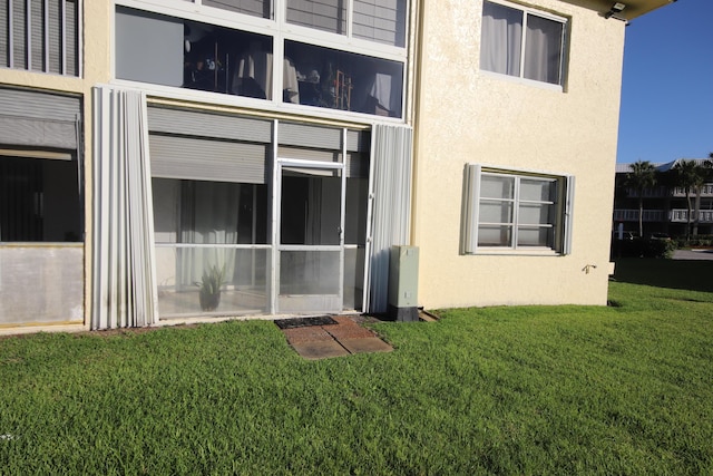 9842 Marina Blvd Unit 711, Boca Raton, FL 33428 - back of property featuring stucco siding and a lawn