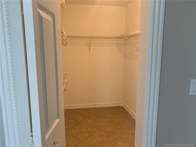spacious closet with tile patterned flooring