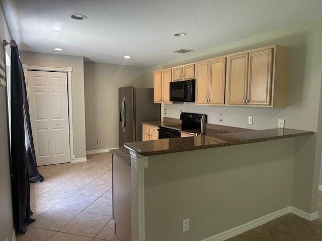 kitchen with black microwave, range with electric cooktop, stainless steel fridge, a peninsula, and light brown cabinets