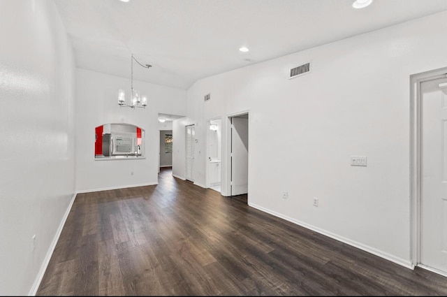unfurnished living room with a chandelier, dark wood-style floors, baseboards, and recessed lighting