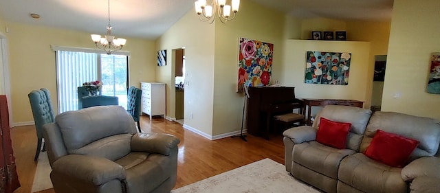 1132 SE Oriental Ave, Port Saint Lucie, FL 34952 - living room with a chandelier, wood finished floors, vaulted ceiling, and baseboards