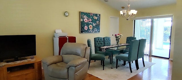 1132 SE Oriental Ave, Port Saint Lucie, FL 34952 - dining room featuring a chandelier, light wood-type flooring, and vaulted ceiling