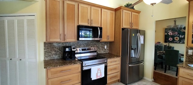 1132 SE Oriental Ave, Port Saint Lucie, FL 34952 - kitchen featuring appliances with stainless steel finishes, backsplash, dark stone counters, and light brown cabinetry