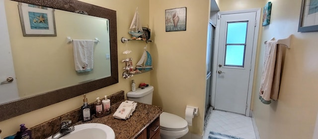 1132 SE Oriental Ave, Port Saint Lucie, FL 34952 - full bathroom featuring a stall shower, toilet, tile patterned flooring, vanity, and baseboards