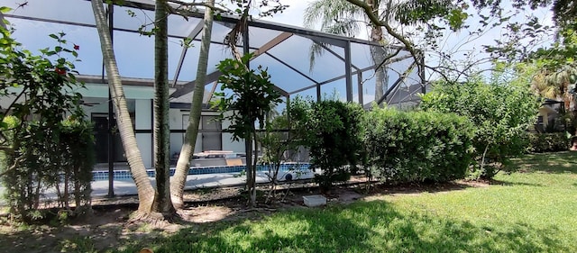 1132 SE Oriental Ave, Port Saint Lucie, FL 34952 - view of green lawn featuring a lanai and an outdoor pool