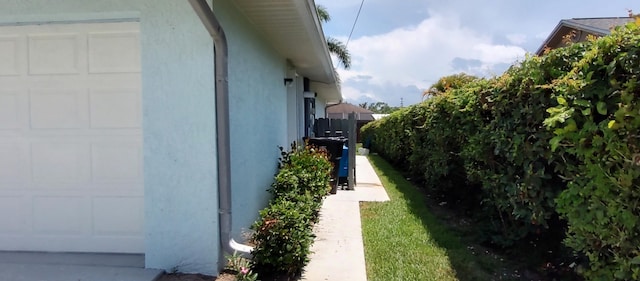 1132 SE Oriental Ave, Port Saint Lucie, FL 34952 - view of side of property featuring stucco siding and an attached garage
