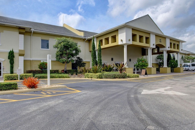 view of building exterior with uncovered parking