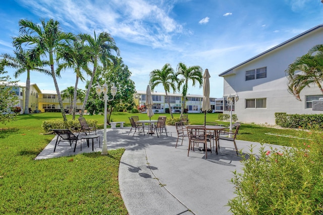 view of home's community featuring a lawn and a patio