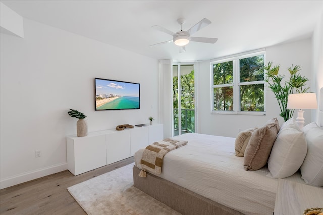 500 SE Mizner Blvd Unit A202, Boca Raton, FL 33432 - bedroom with light wood-style flooring, baseboards, a ceiling fan, and access to outside