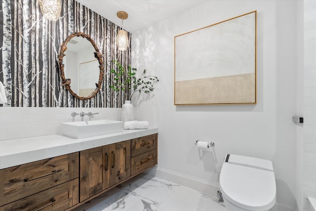 500 SE Mizner Blvd Unit A202, Boca Raton, FL 33432 - bathroom featuring toilet, vanity, marble finish floors, and baseboards