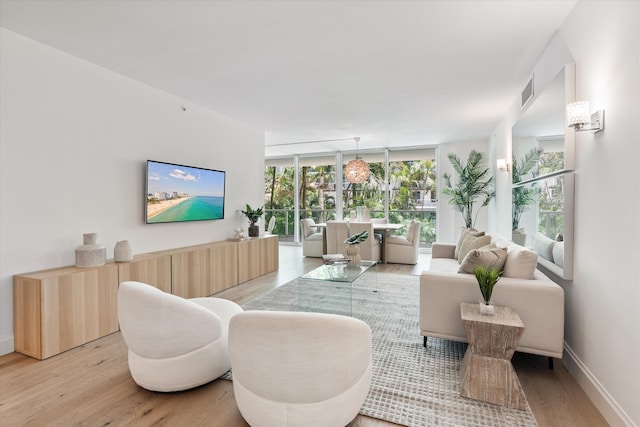 500 SE Mizner Blvd Unit A202, Boca Raton, FL 33432 - living area with light wood-style floors, baseboards, and expansive windows