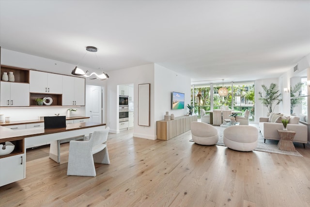 500 SE Mizner Blvd Unit A202, Boca Raton, FL 33432 - kitchen with open shelves, stainless steel oven, black microwave, a chandelier, and white cabinetry