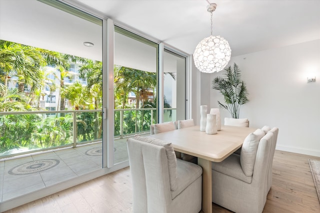 500 SE Mizner Blvd Unit A202, Boca Raton, FL 33432 - dining room featuring light wood-style flooring, baseboards, and a chandelier