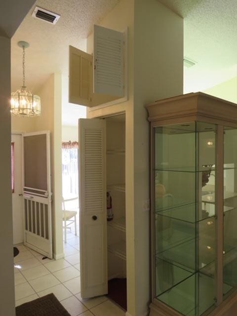 816 Sky Pine Way Unit H, Greenacres, FL 33415 - bathroom with a chandelier, tile patterned floors, and a textured ceiling