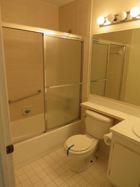 816 Sky Pine Way Unit H, Greenacres, FL 33415 - full bathroom with tile patterned floors, enclosed tub / shower combo, vanity, and toilet