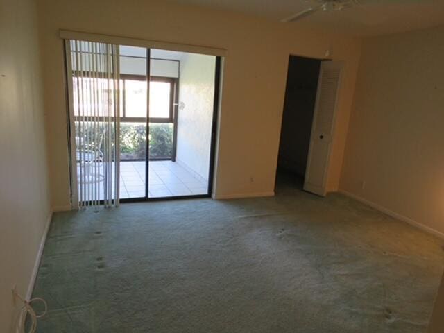 816 Sky Pine Way Unit H, Greenacres, FL 33415 - carpeted spare room featuring baseboards and a ceiling fan