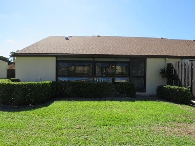 816 Sky Pine Way Unit H, Greenacres, FL 33415 - rear view of house with stucco siding and a shingled roof