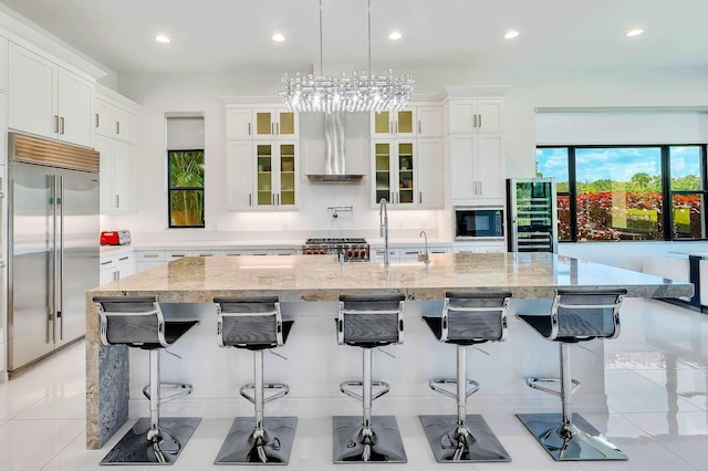 9219 Grand Prix Ln, Boynton Beach, FL 33472 - kitchen featuring built in appliances, a sink, beverage cooler, recessed lighting, and wall chimney exhaust hood