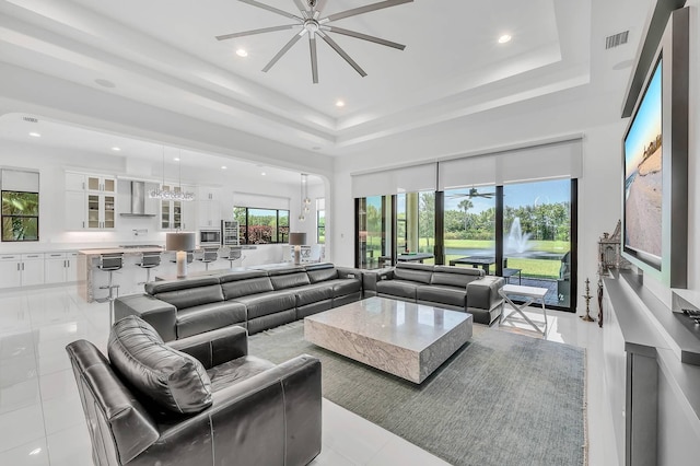 9219 Grand Prix Ln, Boynton Beach, FL 33472 - living area with ceiling fan, a tray ceiling, a high ceiling, and recessed lighting