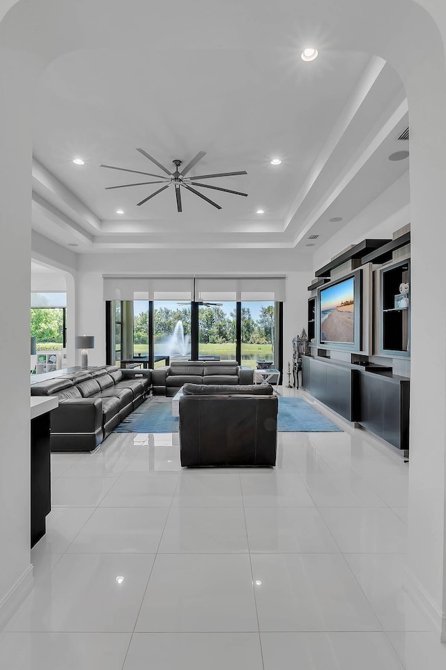 9219 Grand Prix Ln, Boynton Beach, FL 33472 - tiled living area with a raised ceiling, ceiling fan, healthy amount of natural light, arched walkways, and recessed lighting