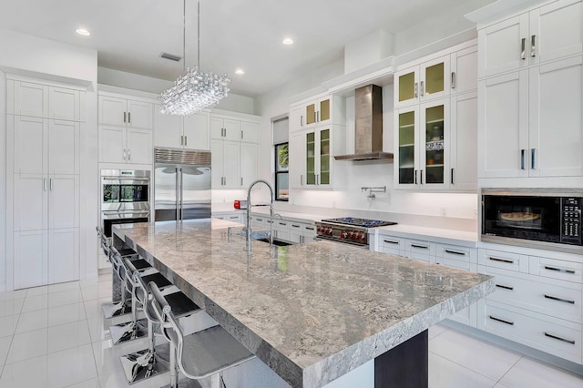 9219 Grand Prix Ln, Boynton Beach, FL 33472 - kitchen with built in appliances, a sink, wall chimney range hood, light tile patterned flooring, and white cabinetry