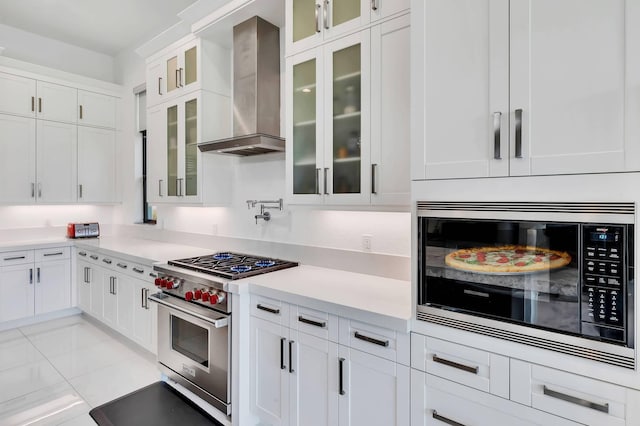 9219 Grand Prix Ln, Boynton Beach, FL 33472 - kitchen featuring built in microwave, luxury range, wall chimney range hood, white cabinets, and light countertops