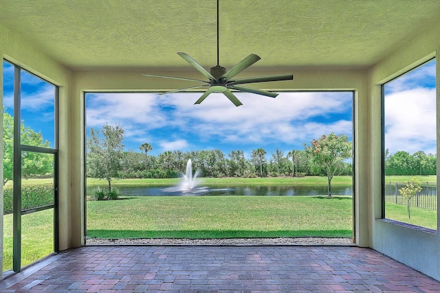 9219 Grand Prix Ln, Boynton Beach, FL 33472 - unfurnished sunroom with a water view, brick floors, a textured ceiling, and healthy amount of natural light