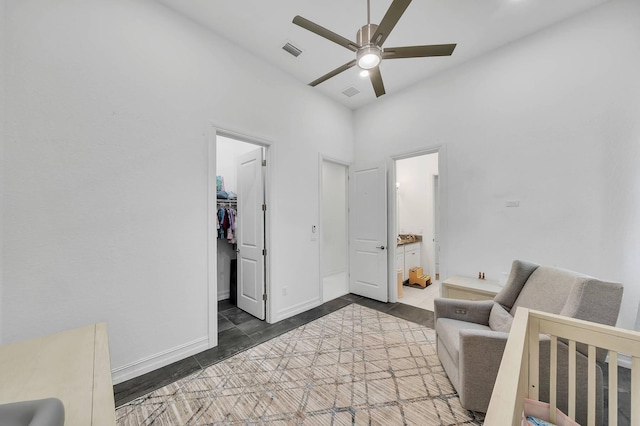 9219 Grand Prix Ln, Boynton Beach, FL 33472 - tiled bedroom featuring a walk in closet, a closet, ceiling fan, and ensuite bathroom