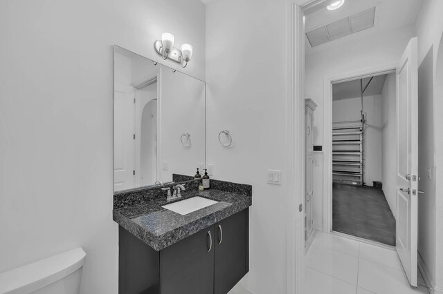 9219 Grand Prix Ln, Boynton Beach, FL 33472 - bathroom featuring toilet, vanity, and tile patterned floors