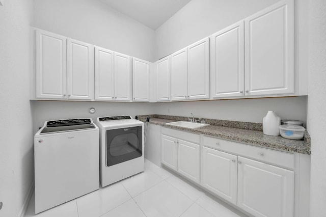 9219 Grand Prix Ln, Boynton Beach, FL 33472 - laundry area with washing machine and dryer, light tile patterned floors, and cabinet space