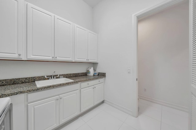 9219 Grand Prix Ln, Boynton Beach, FL 33472 - washroom with light tile patterned flooring, baseboards, and cabinet space