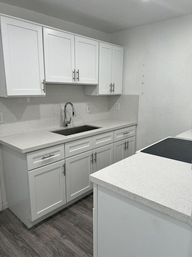 132 E Central Blvd, Lantana, FL 33462 - kitchen with a sink, dark wood-type flooring, white cabinets, light countertops, and stove