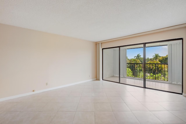 4411 Trevi Ct Unit 303, Lake Worth, FL 33467 - spare room with baseboards and a textured ceiling
