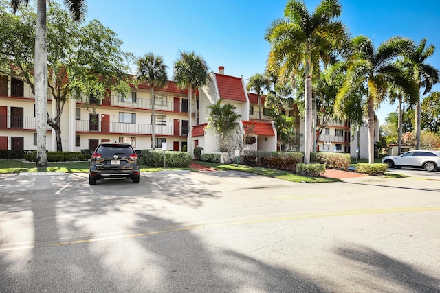 4411 Trevi Ct Unit 303, Lake Worth, FL 33467 - view of building exterior with uncovered parking and a residential view