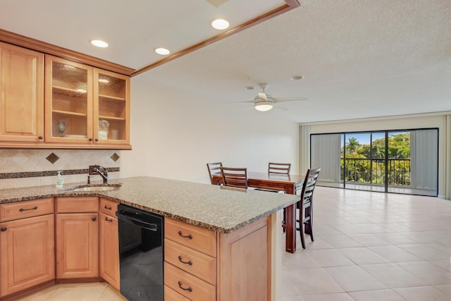 4411 Trevi Ct Unit 303, Lake Worth, FL 33467 - kitchen with black dishwasher, a sink, tasteful backsplash, light stone counters, and recessed lighting