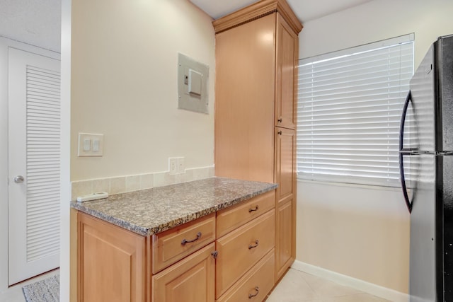 4411 Trevi Ct Unit 303, Lake Worth, FL 33467 - kitchen featuring freestanding refrigerator, light tile patterned floors, light brown cabinets, and electric panel