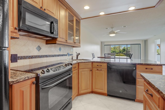 4411 Trevi Ct Unit 303, Lake Worth, FL 33467 - kitchen featuring black appliances, a sink, dark stone counters, a ceiling fan, and tasteful backsplash