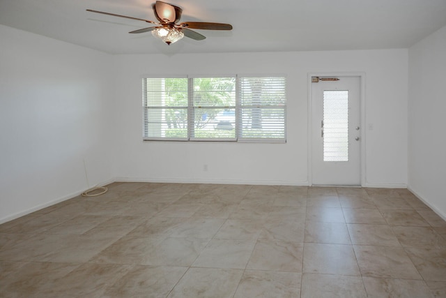 134 Southampton Unit B, West Palm Beach, FL 33417 - empty room with healthy amount of natural light, ceiling fan, and baseboards