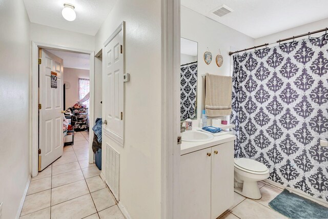 6528/6530 12th St W, Bradenton, FL 34207 - full bath featuring tile patterned flooring, toilet, vanity, a shower with shower curtain, and baseboards