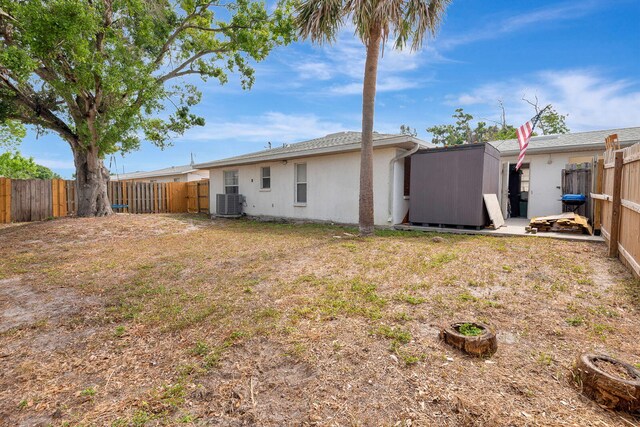 6528/6530 12th St W, Bradenton, FL 34207 - fenced backyard featuring cooling unit, a storage unit, and an outdoor structure