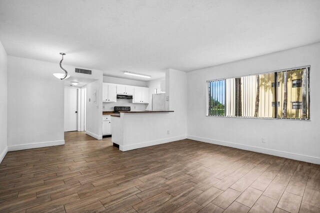 1618 Meadows Cir W, Boynton Beach, FL 33436 - unfurnished living room featuring dark wood finished floors and baseboards