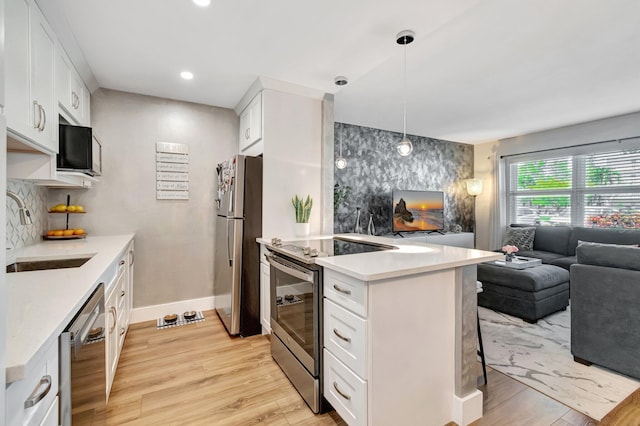 1044 Cambridge C Unit 1044, Deerfield Beach, FL 33442 - kitchen featuring appliances with stainless steel finishes, open floor plan, a sink, light wood finished floors, and recessed lighting