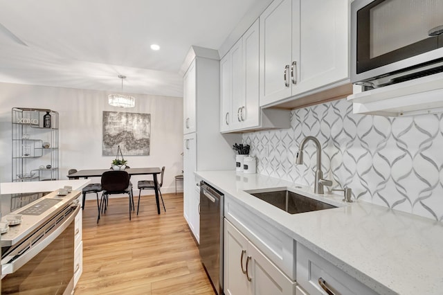 1044 Cambridge C Unit 1044, Deerfield Beach, FL 33442 - kitchen with a sink, appliances with stainless steel finishes, recessed lighting, backsplash, and light wood-style floors