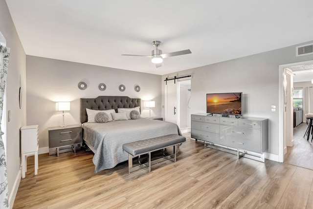 1044 Cambridge C Unit 1044, Deerfield Beach, FL 33442 - bedroom featuring light wood-style floors, a barn door, baseboards, and ceiling fan
