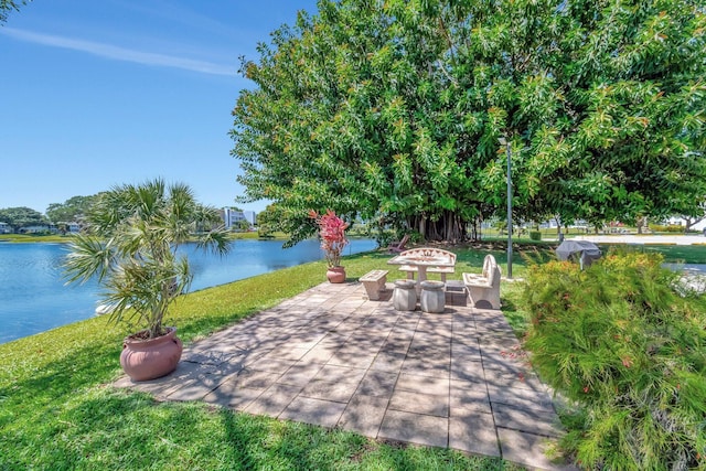 1044 Cambridge C Unit 1044, Deerfield Beach, FL 33442 - view of patio with an outdoor fire pit and a water view
