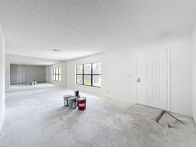 5701 Autumn Ridge Rd, Lake Worth, FL 33463 - unfurnished living room featuring a textured ceiling and concrete floors