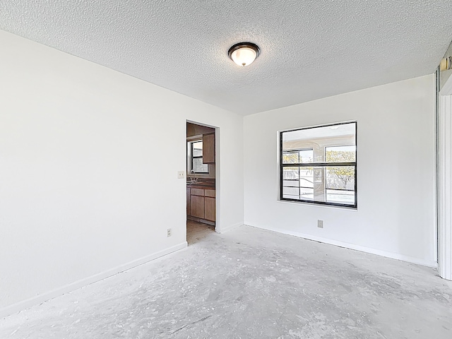 5701 Autumn Ridge Rd, Lake Worth, FL 33463 - spare room featuring unfinished concrete floors, baseboards, and a textured ceiling