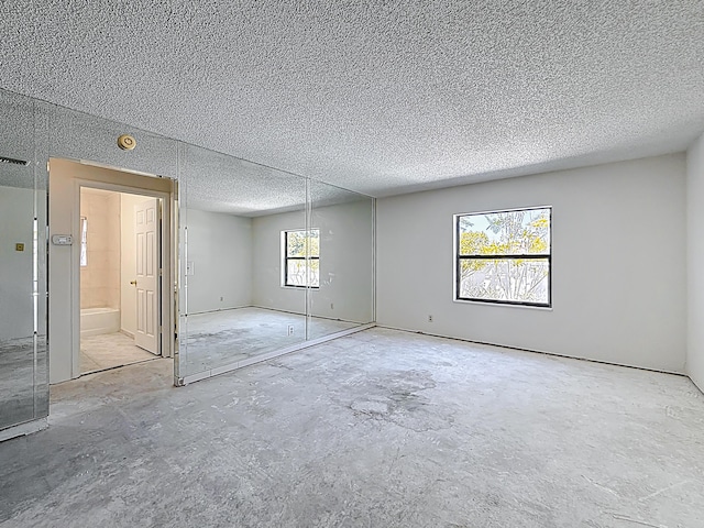 5701 Autumn Ridge Rd, Lake Worth, FL 33463 - unfurnished bedroom featuring concrete floors and a textured ceiling