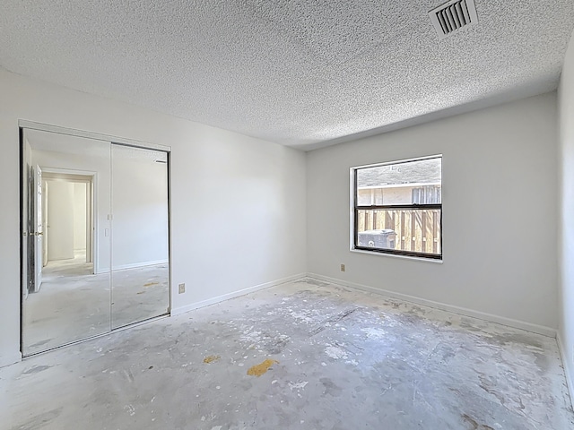 5701 Autumn Ridge Rd, Lake Worth, FL 33463 - unfurnished bedroom with a textured ceiling, a closet, and concrete flooring