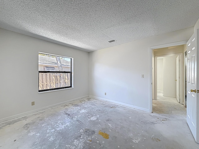 5701 Autumn Ridge Rd, Lake Worth, FL 33463 - empty room featuring a textured ceiling, concrete floors, and baseboards